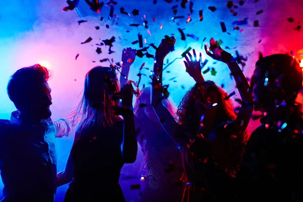 People dancing in confetti — Stock Photo, Image