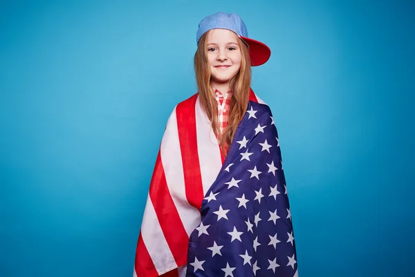 Girl wrapped in American flag Royalty Free Stock Images