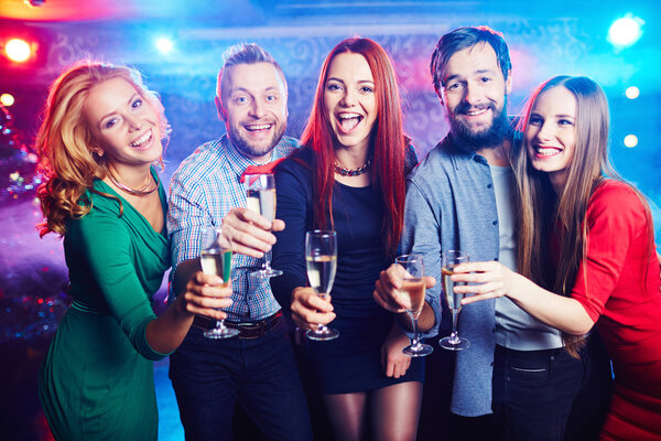 friends drinking champagne at nightclub