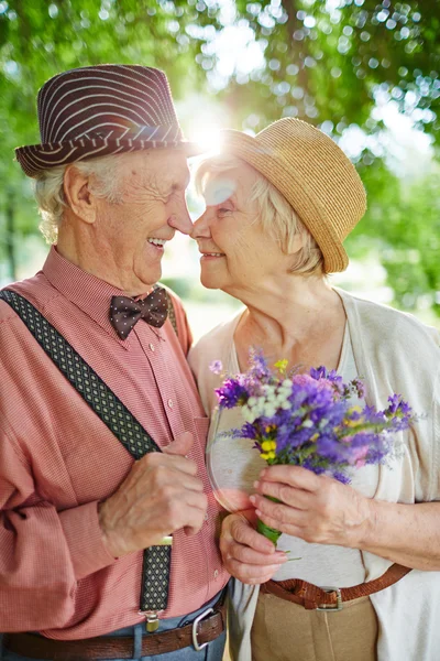 Amorous seniors touching by their noses — Stock Photo, Image