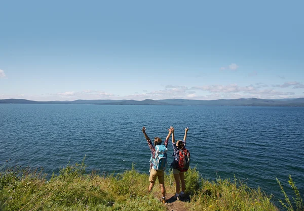 Ecstatic hikers  standing by the sea — Stock Photo, Image