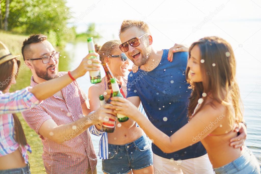 friends toasting with bottles of beer