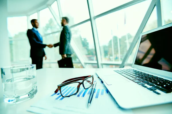 Werkplek en handshaking zakenlieden — Stockfoto