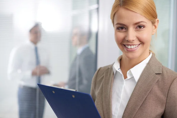 Businesswoman in formal wear with folder Stock Image