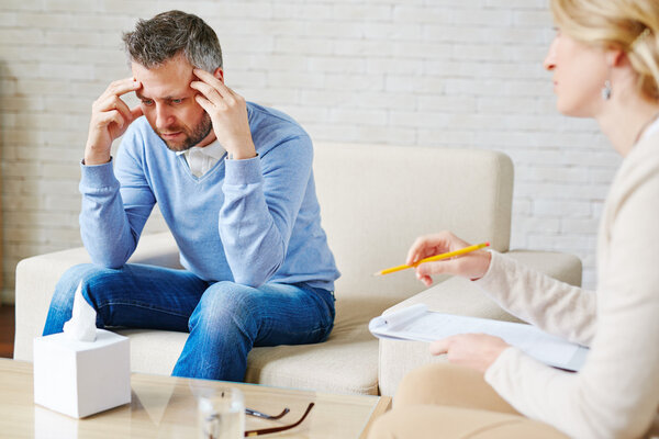 Stressed man visiting his psychologist