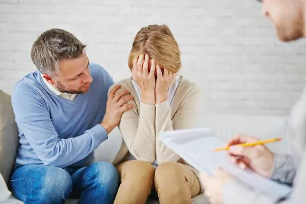 Man reassuring his wife while visiting psychologist — Stock Photo, Image