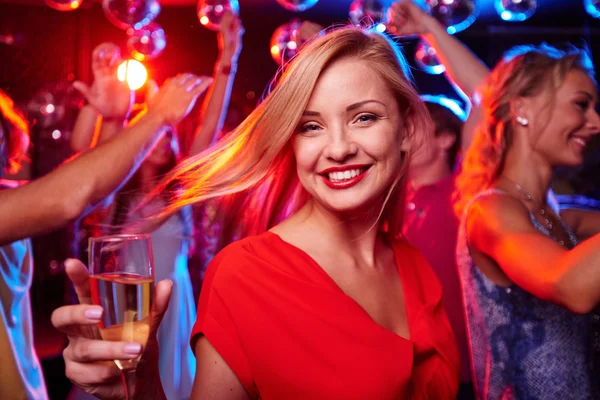 Girl with flute of champagne in night club — Stock Photo, Image