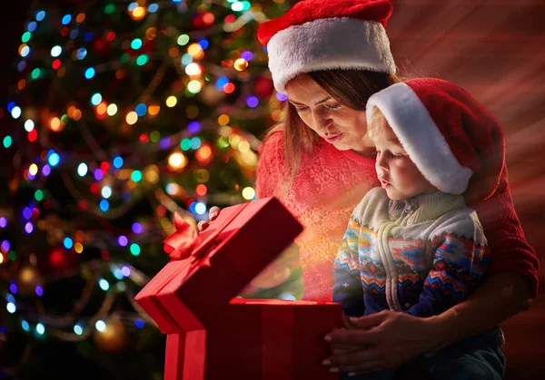 Woman and son opening Christmas present Stock Image