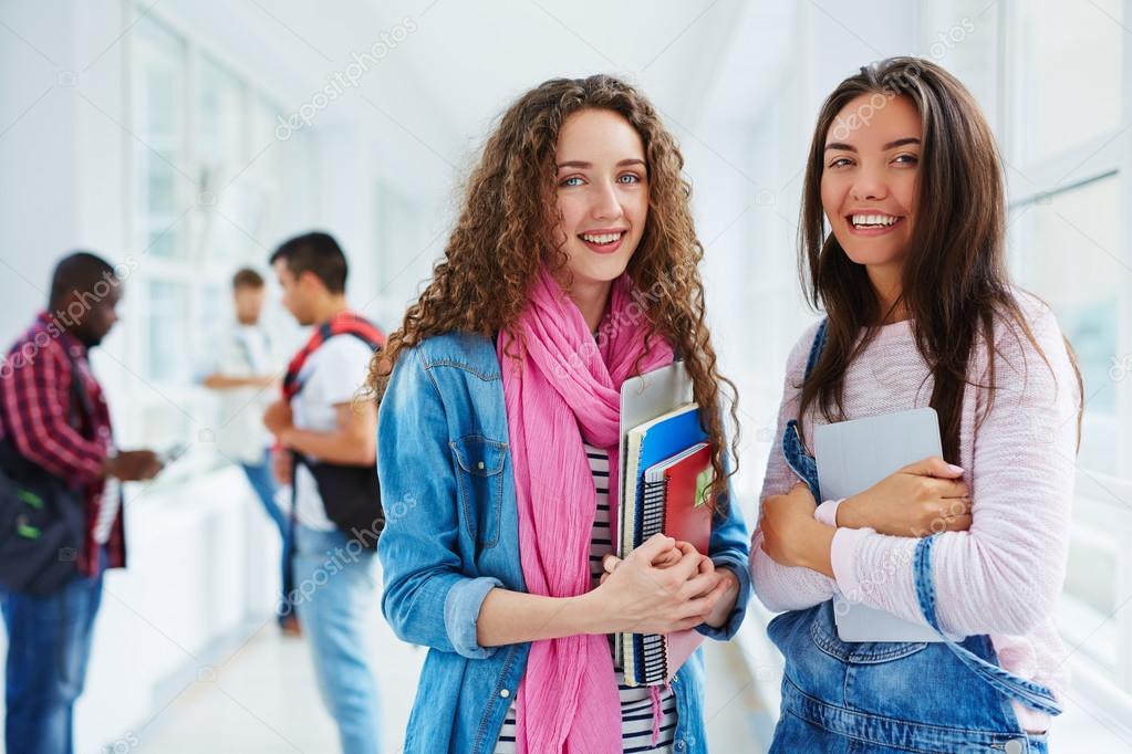 teenage girls  in college corridor