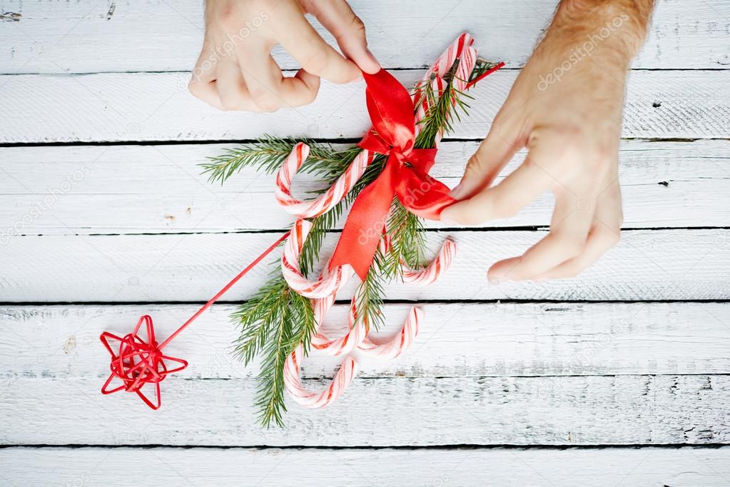 Human hands binding Christmas bouquet
