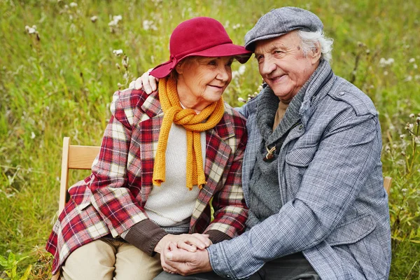 Personas mayores jubiladas relajándose en el césped verde —  Fotos de Stock