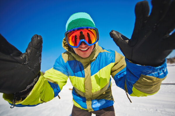 Sportsman snowboarding in winter