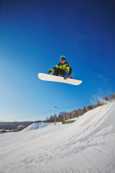 Sportsman snowboarding in winter