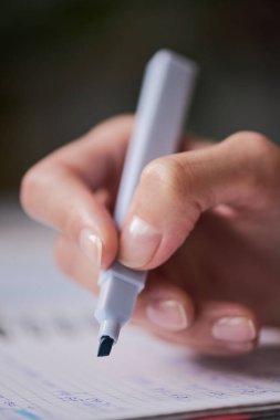 Kağıt üzerinde fosforlu kalem tutan kadın, manikürlü tırnakları ve titiz tutuşu gösteren yakın çekim, yaratıcı ya da eğitici aktivitelere katılan kadın, el hareketine odaklan