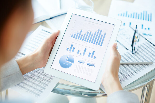 Businesswoman studying data in touchpad