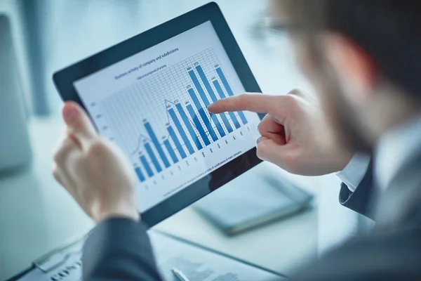 Businessman pointing at chart  in digital tablet — Stock Photo, Image