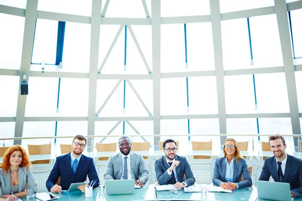 Successful managers sitting in conference hall — Stock Photo, Image