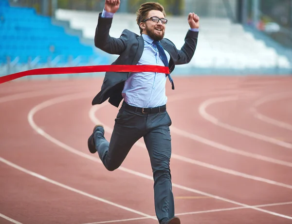 Businessman reaching finish ribbon — Stock Photo, Image