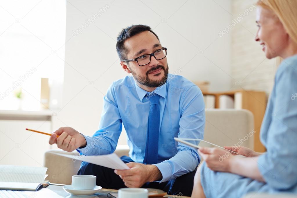 employees discussing strategies at meeting