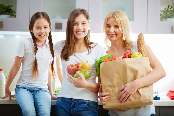 Vrouw en meisjes in de keuken — Stockfoto