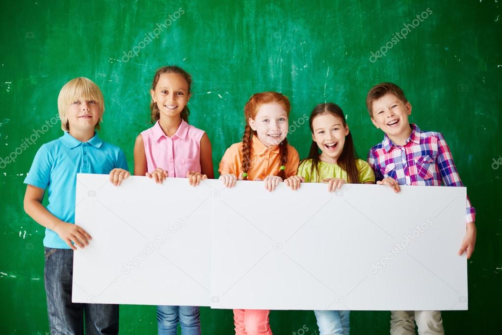 Friendly schoolkids with blank paper