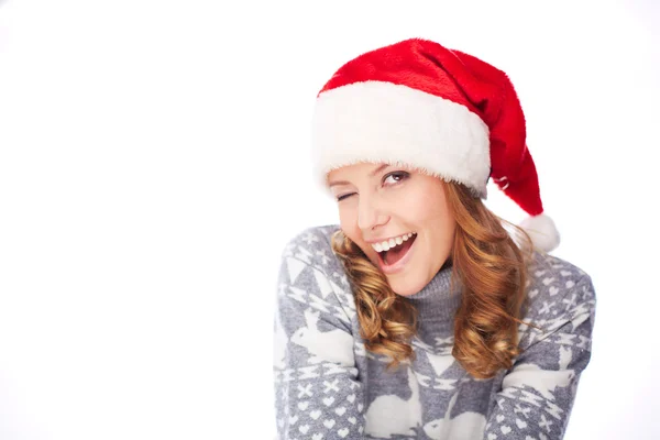 Young girl in Santa cap winking — Stock Photo, Image