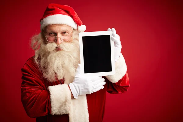 Noel Baba holding touchpad — Stok fotoğraf