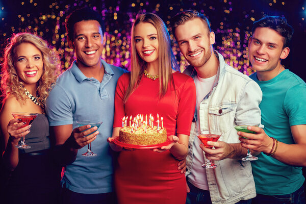 friends with cocktails and birthday cake