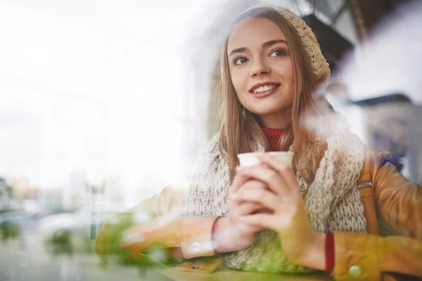 Happy woman having drink in cafe — Stock Photo, Image