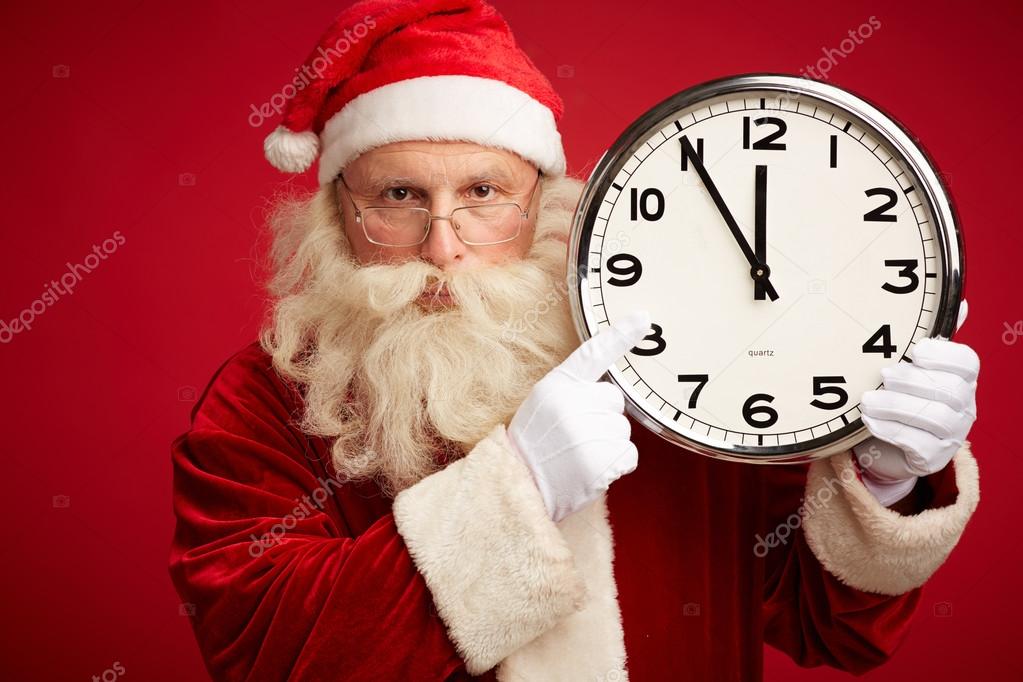 Santa Claus showing at clock