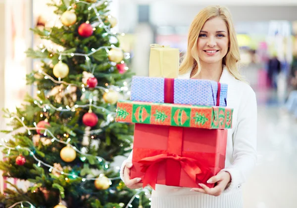 Woman with heap of Christmas gifts — Stock Photo, Image