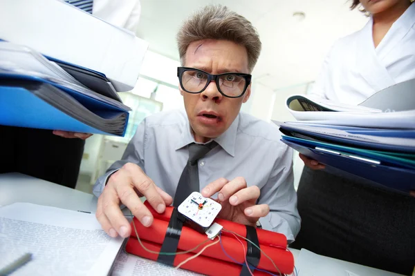 Annoyed businessman preparing dynamite — Stock Photo, Image