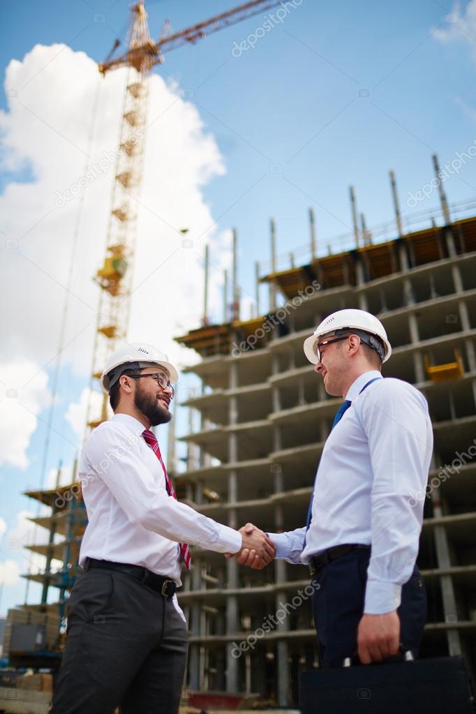 Young architects or builders handshaking