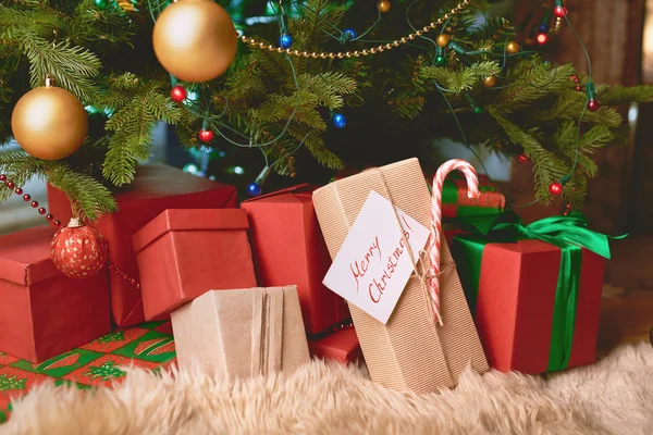 Christmas gifts under fir-tree — Stock Photo, Image