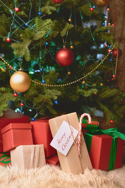 Christmas gifts under fir-tree — Stock Photo, Image