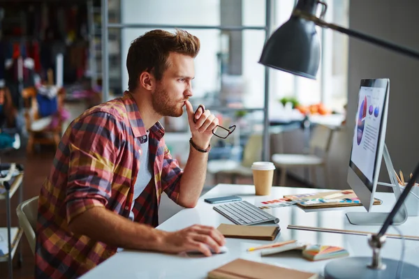 Modern designer sitting in front of computer