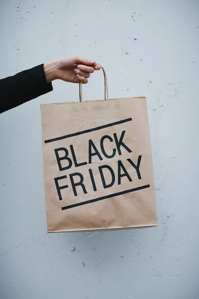 Hand holding paperbag with  Black Friday — Stock Photo, Image