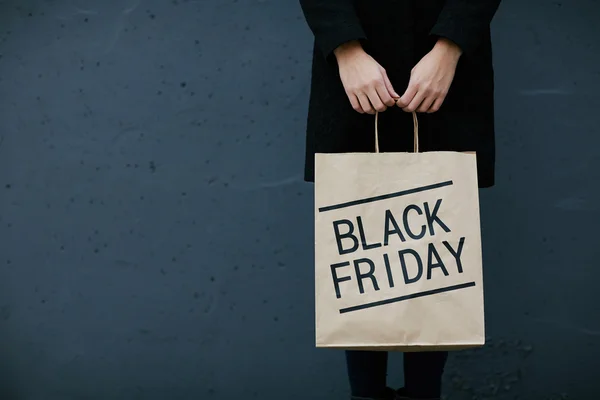 Woman  holding paperbag with  Black Friday — Stock Photo, Image