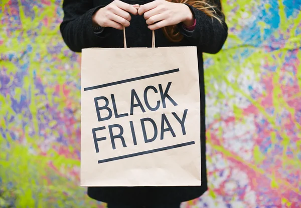 Girl with Black Friday shopping bag — Stock Photo, Image