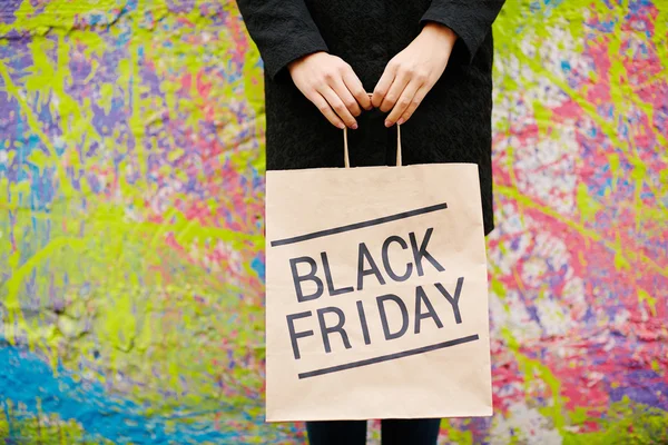 Girl with Black Friday shopping bag — Stock Photo, Image