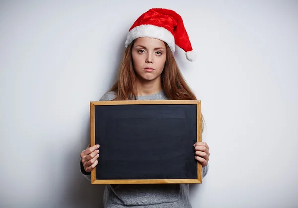 칠판을 보여주는 산타 모자에 소녀 — 스톡 사진