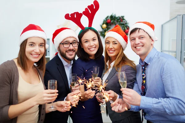 Colleghi con champagne e luci del Bengala — Foto Stock