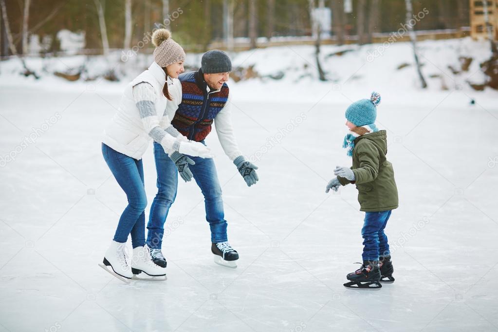 parents and son on rink