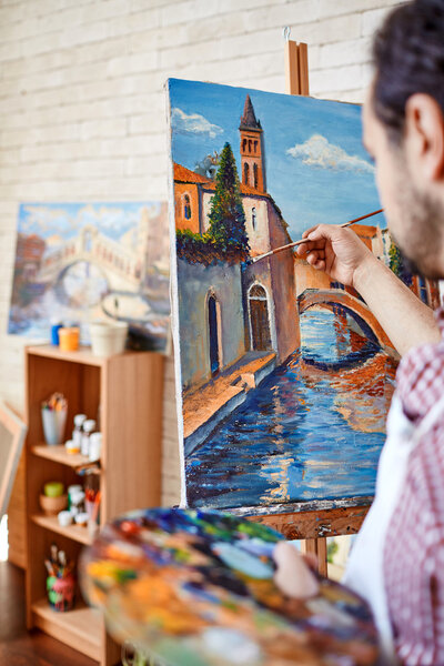 painter painting on canvas