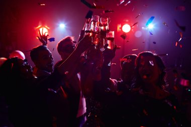 friendly people toasting in night club