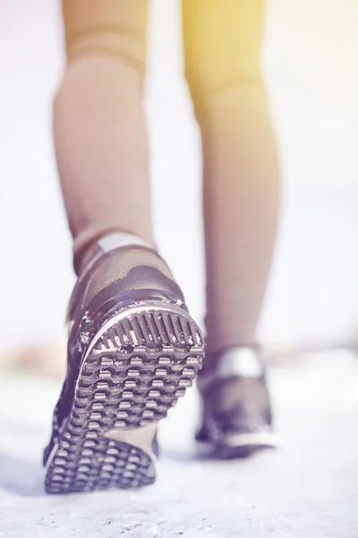 Piedi femminili che corrono sulla neve — Foto Stock