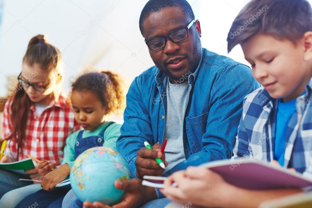 pupils studying with teacher