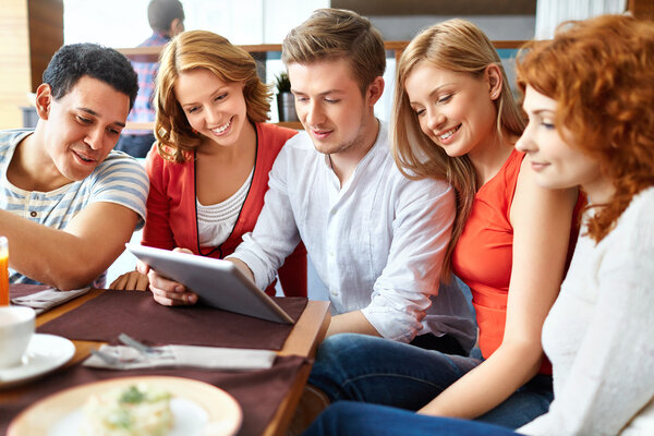 Friends with touchpad in cafe