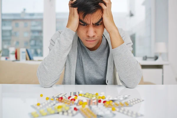 Young man with pills — Stock Photo, Image