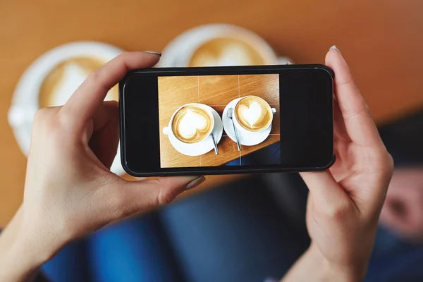 Two cups  on smartphone screen — Stock Photo, Image